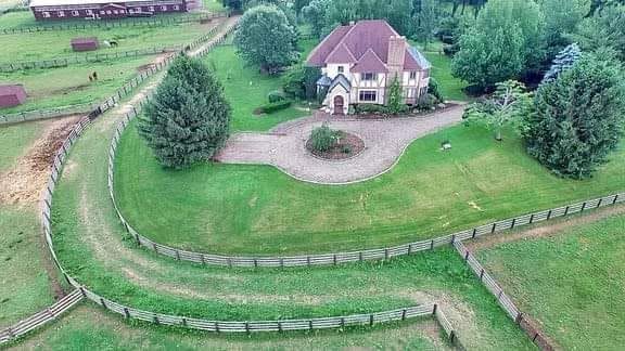 Aerial view of Thunder Ridge Farms — a real working horse farm with white fences and rolling Warren County hills